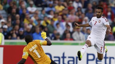 Qatar's goalkeeper Qasem Burhan saves a shot by the UAE's Ali Mabkhout during their Asian Cup Group C soccer match at the Canberra stadium in Canberra January 11, 2015. REUTERS/Tim Wimborne