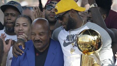 LeBron James, right, embraces Cleveland Browns legend Jim Brown at the Cleveland Cavaliers NBA championship parade. Tony Dejak / AP Photo