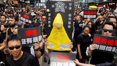 Protesters carry a yellow raincoat in memory of a man, who died after falling from a scaffolding at the Pacific Place complex while protesting, during a demonstration demanding Hong Kong's leaders to step down and withdraw the extradition bill, in Hong Kong, China. Reuters