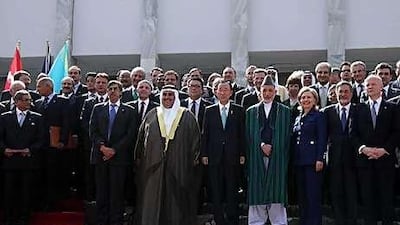 Delegates pose for a photograph with Hamid Karzai, the president of Afghanistan, centre, in Kabul yesterday.