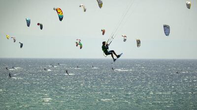 A kite suffer participates in the Guinness World Record attempt for the most kitesurfers sailing together at one time in Tarifa, Spain. 352 participants set a new Guinness World Record, breaking the previous record of 318. Sergio Camacho / Getty