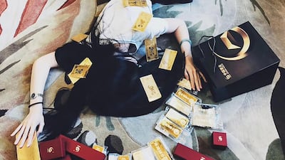 One post shows a girl called Wei Shengju on the floor surrounded by gold bars. AFP