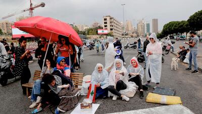Lebanese protester have lunch together on a blocked avenue in the centre of the capital Beirut during ongoing anti-government demonstrations. AFP