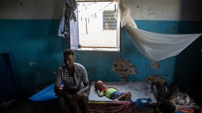 Abdualha, 28, sits in a shelter with his sick son at the camp in Sudan. ‘I left Eritrea last May to come to Sudan, looking for hope of a better life. My son needs an operation on his brain and I'm not able to find a doctor for him until now,’ he says. Getty