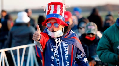 A supporter of US President Donald Trump gives a thumb's up as he arrives to attend his final Make America Great Again rally of the 2020 US Presidential campaign at Gerald R. Ford International Airport on November 2, 2020, in Grand Rapids, Michigan. / AFP / JEFF KOWALSKY