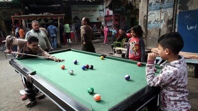 Egyptian boys play billiards at a street in Bulaq neighborhood, Cairo, Egypt. Khaled Elfiqi / EPA