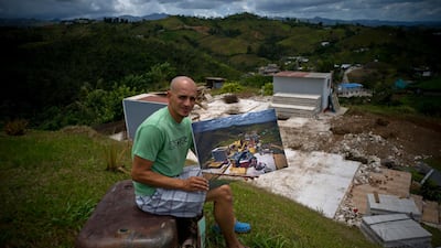 Rafael Reyes holds a printed photo of him taken on October 7, 2017. The 41-year-old father and husband has been living with his in-laws and says he plans to rebuild his home with US federal assistance. All photos by Ramon Espinosa / AP Photo