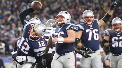 New England Patriots quarterback Tom Brady celebrates after rushing in for a touchdown in his team's NFL play-offs win over the Baltimore Ravens on Saturday. CJ Gunther / EPA / January 10, 2015