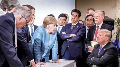 A viral photo German chancellor Angela Merkel posted of her and other world leaders standing over a seated Donald Trump at the G7 summit in 2018 was likened to a Renaissance-era artwork. In the photo, Trump, arms folded and eyes glaring, is surrounded by a group of world leaders and their advisers, including Japanese prime minister Shinzo Abe, French president Emmanuel Macron and British prime minister Theresa May. Twitter