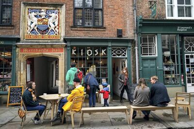 Customers sit outside a cafe in York, England in October. While eateries were still open in October, less customers were eating out amid a rise in Covid cases causing a 14.4 per cent fall in output across the accommodation and restaurant sector. Getty Images