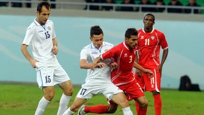 The UAE left-back Walid Abbas, second right, tries to evade the challenge of an Uzbekistan defender while Ahmed Khalil, No 11, looks on. Courtesy of UAE FA