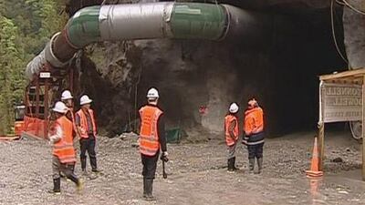 Miners at the entrance of a remote mine in Grey District, New Zealand rocked by an explosion today that trapped 27 miners underground.