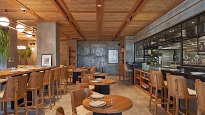 Lowe features wooden interiors and an open kitchen with wood-fired oven. Courtesy Lowe