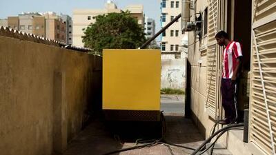 Mohamed Zaman stands beside a generator at the Alishba Building, which has closed down for five days due to diesel shortages. Northern Emirates residents worry that electrical and fuel shortages will affect power as the summer heat sets in.
