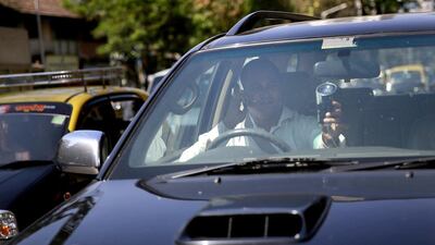 Uber driver Dinish Karamsesula, whose employer partnered with the company in Mumbai, drives his black SUV in Mumbai, India. Riding on its startup success and flush with fresh capital, taxi-hailing smartphone app Uber is making a big push into Asia. Rafiq Maqbool / AP Photo