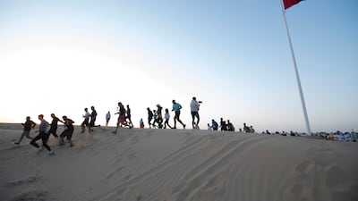 Participants brave the desert to run the marathon at Al Marmoom Ultramarathon at Expo 2020 Dubai Lake. Ruel Pableo for The National