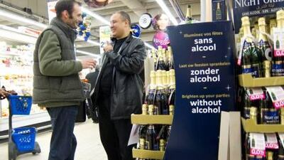 Rashid Gacem, right, presents Night Orient, champagne-type drink that is marketed as halal and with and alcohol percentage of 0.0 per cent, for a tasting to pre-christmas shoppers at the Cora supermarket in the Parisian suburb Arceuil.