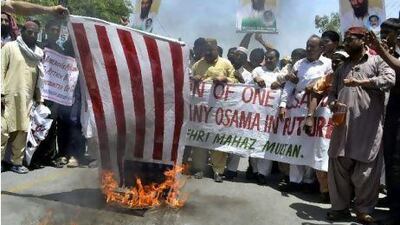Pakistani demonstrators burn a US flag during a protest in Multan against the killing of the al Qa'eda leader Osama bin Laden.