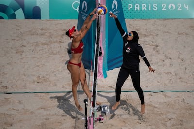 Doaa Elghobashy, right, defies the French ban on hijabs while playing volleyball against Spain. AP