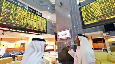 MSCI upgraded the UAE and Qatar to emerging markets status last month. Above, investors monitor trading at the Abu Dhabi Securities Exchange. Ben Job / Reuters