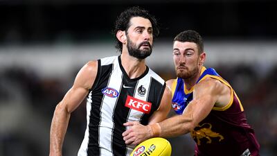 Brodie Grundy of the Magpies handballs during the AFL match against Brisbane Lions at The Gabba on April 14, 2022 in Brisbane, Australia. Getty