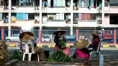 Malaysian women sort stacks of vegetables outside a wholesale market in Kuala Lumpur. AFP
