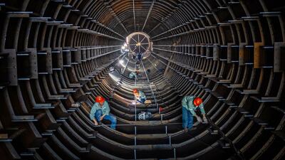 Employees work on a steel tube tower production line at a factory in Haian, in eastern China's Jiangsu province. AFP