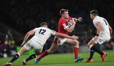 Wales' Nick Tompkins is tackled by England's Owen Farrell (L) during the Six Nations rugby match at Twickenham. EPA