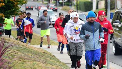 Manny Pacquiao jogs with mates and supporters on Tuesday in Los Angeles ahead of the 'fight of the century' against Floyd Mayweather on May 2. Frederic J Brown / AFP