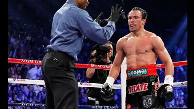 Referee Kenny Bayless gives a count to Juan Manuel Marquez of Mexico after Marquez was knocked down by Manny Pacquiao in the fifth round. Steve Marcus / Reuters