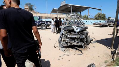 Security personnel seen next to the remnants of a vehicle at the scene of a gun attack at Kaam checkpoint in Zliten east of Tripoli, Libya. Ismail Zitouny / Reuters