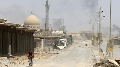 An Iraqi boy rides a bicycle in west Mosul's Al Saha neighbourhood on May 29, 2017. Karim Sahib / AFP