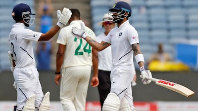 India's cricketer Virat Kohli, right, celebrates his hundred with Ajinkya Rahane. AP