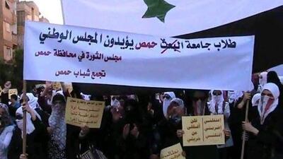 Students protesting against Syria's president Bashar Al Assad march through the streets of Homs last October.