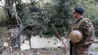 A Lebanese soldier near a destroyed army vehicle at Zibqin, close to the border with Israel. The army has increased its presence in the south. EPA
