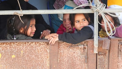 Palestinian girls leave their homes after the Israeli army issued eviction orders for Jabalia in the northern Gaza Strip on March 25, 2025. Reuters