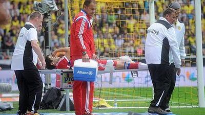 Bayern Munich's Javi Martinez is carried off the field with an injury during the DFL Supercup soccer match Borussia Dortmund vs FC Bayern Munich at Signal Iduna Park in Dortmund, Germany, 13 August 2014.