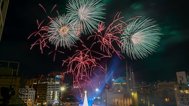 Fireworks explode above a Christmas tree beside the Muhammad Al Amine Mosque in Beirut. EPA