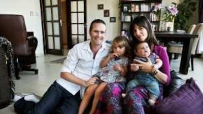 Jasmine Collins, 38, seen with her husband, Alex, 34, their 11-week-old son, Indiana, and three-year-old daughter, Amber Lily, travelled to the UK to have a home birth.