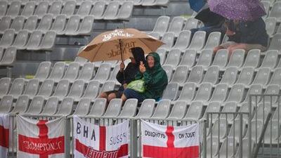 Cricket fans sit out the rainstorm at Dunedin.