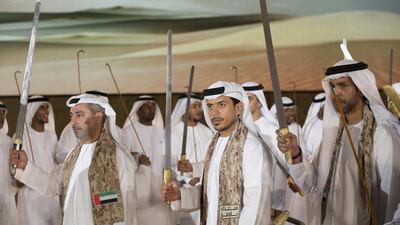Sheikh Nahyan bin Hamdan bin Mohamed Al Nahyan, left, Sheikh Sultan bin Tahnoon Al Nahyan, Chairman of the Abu Dhabi Department of Transport and Abu Dhabi Executive Council Member, centre, and Sheikh Khalifa bin Mohamed bin Khaled Al Nahyan, right, dance. Ryan Carter / Crown Prince Court - Abu Dhabi