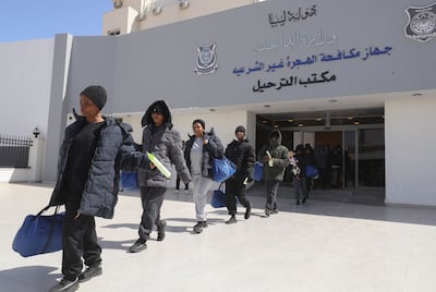 More than 170 Nigerian migrants queue to board buses to Tripoli's Mitiga International Airport. AFP