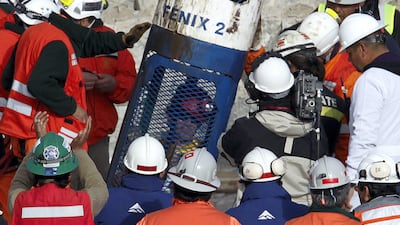 Miner Alex Vega arrives inside the capsule as the tenth to be rescued in Copiapo October 13, 2010. REUTERS