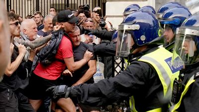 Protesters scuffle with police during the "Enough is Enough" protest in Whitehall, London, following the fatal stabbing of three children at a Taylor Swift-themed summer holiday dance and yoga class on Monday in Southport, Merseyside. AP