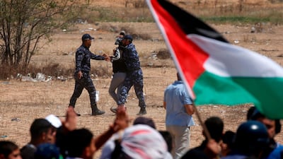 Palestinian Hamas police block protesters from reaching the border fence east of Khan Yunis in the southern Gaza Strip. AFP