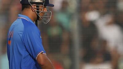 India captain MS Dhoni shown after being dismissed against Bangladesh on Sunday in his side's ODI loss in Dhaka. AM Ahad / AP / June 21, 2015