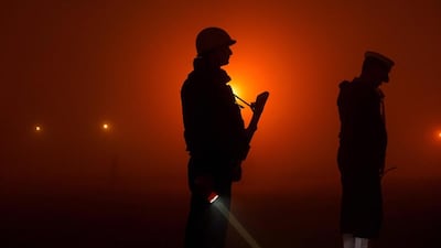 Military personnel stand guard as they rehearse for the forthcoming Republic Day parade at Rajpath in New Delhi. Chandan Khanna / AFP