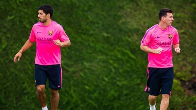 Luis Suarez, left, and Lionel Messi, shown training with Barcelona in August. Alex Caparros / Getty Images / August 17, 2014