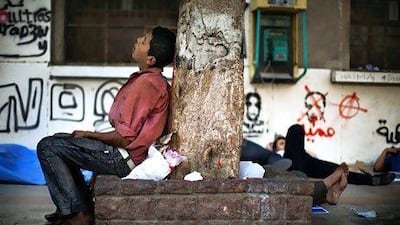 A youth sleeps in Cairo's Tahrir Square. Youth unemployment in the region stands at 25 per cent and is expected to rise. Marco Longari / AFP