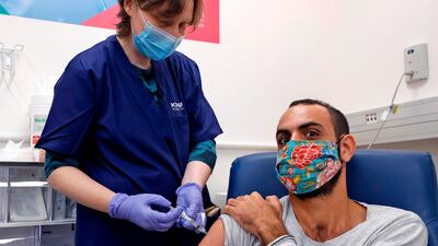 An Israeli volunteer receives the second dose of an experimental Israeli-made Covid-19 vaccine at the Sheba Medical Centre, the country's largest hospital in Ramat Gan. AFP